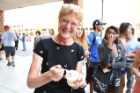 Gayle Hutton, assistant dean and senior director of development for the School of Management, tastes the new flavor before passing out cups of the treat to students.