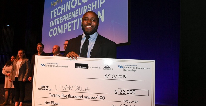 Ogechi Ogoke with a big check for $25,000 after winning first place in the 2019 Panasci Technology Entrepreneurship Competition. Access a larger version of this image. 