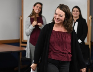 Celine Keefe smiles while leading an improv workshop for Women in Management club members. 