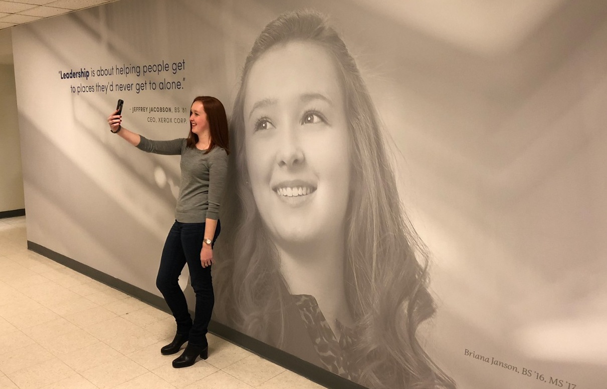 Briana Janson takes a selfie in front of her mural. 