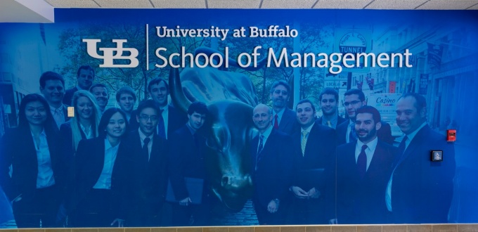 A mural depicting students and alumni on a visit to Wall Street. 