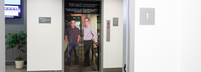 Elevator wrapped with a photo of two entrepreneurs: Eric Reich and Michael Weisman. 