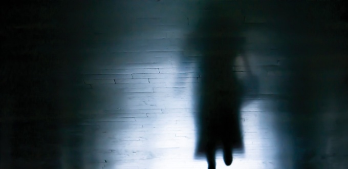 Ominous image of a businesswoman in silhouette. 