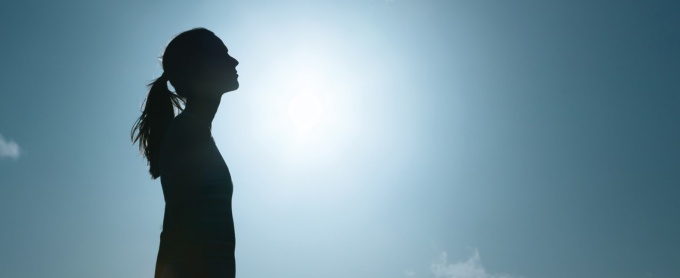 Woman looking up at the sky. 