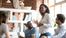 Woman leading a business meeting. Read "Leading through volatility and uncertainty" in this issue of Buffalo Business. 