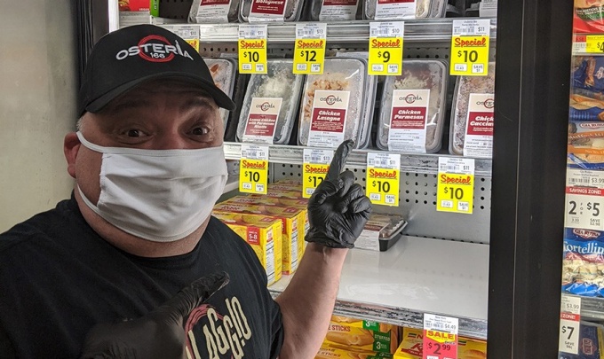 Pitillo stocks the freezer at Dash's Market with meals from his restaurant. 