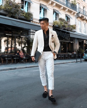 Chan poses outside on a street. 