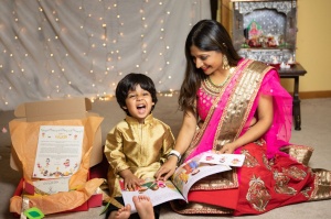 Babaria reading to her son, who is smiling at the camera. 