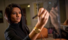 School of Management student Anu Patel writes on a board. Read the Startups section in this issue of Buffalo Business. 