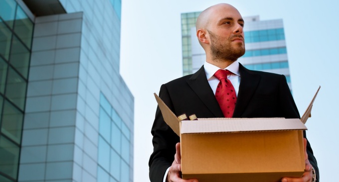 Fired CEO carrying out cardboard box. 
