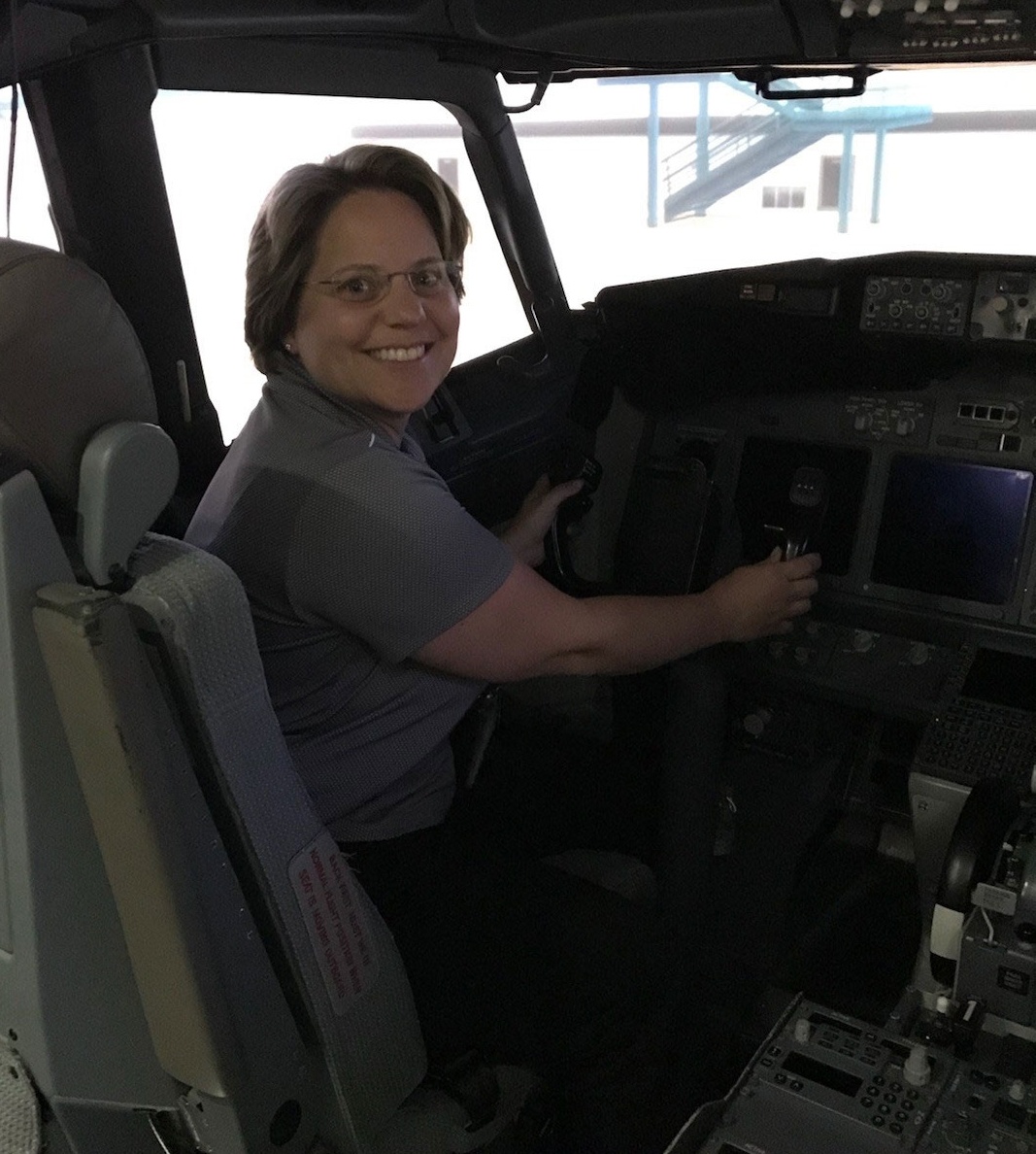 Zoom image: Joanne Rinaldo in a plane's cockpit.