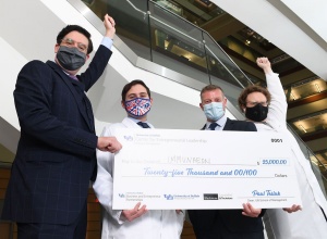 From left, Michael John, James Cooper, Adam Utley and Daniel Fisher hold their $25,000 check. 
