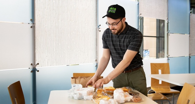 Matthew Taboni repackaging unused food. 