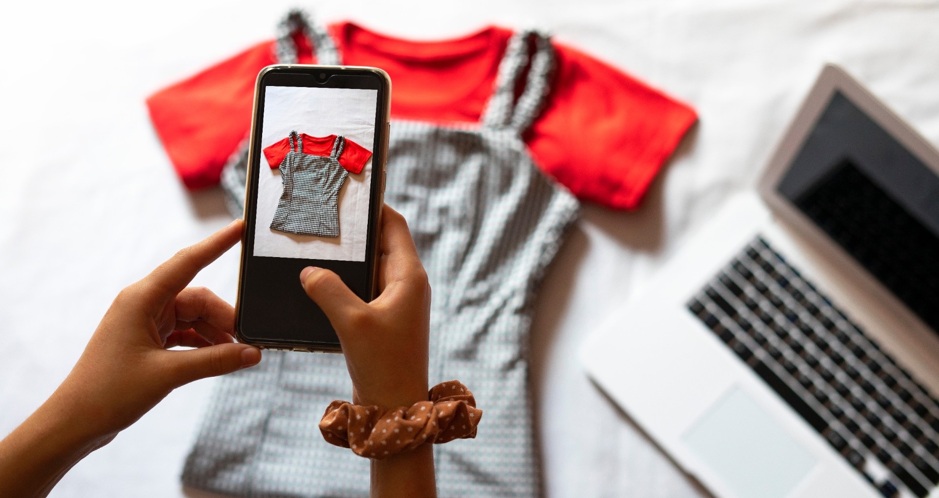 Taking a photo of used clothes with a smartphone. 