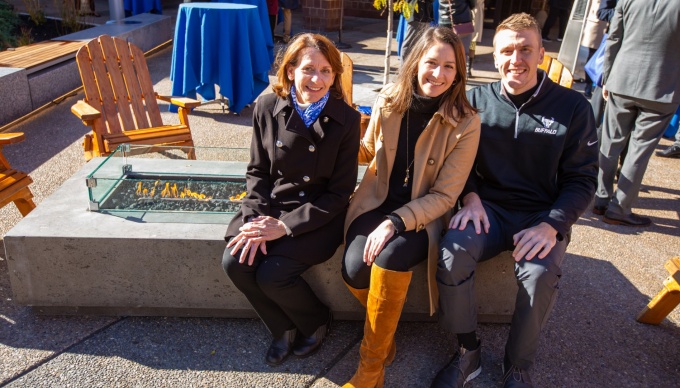 Rosanne, Anna and Eric Stolzenburg sit at the firepit. 