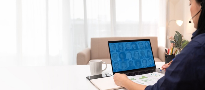 Woman watches an alumni webinar. 