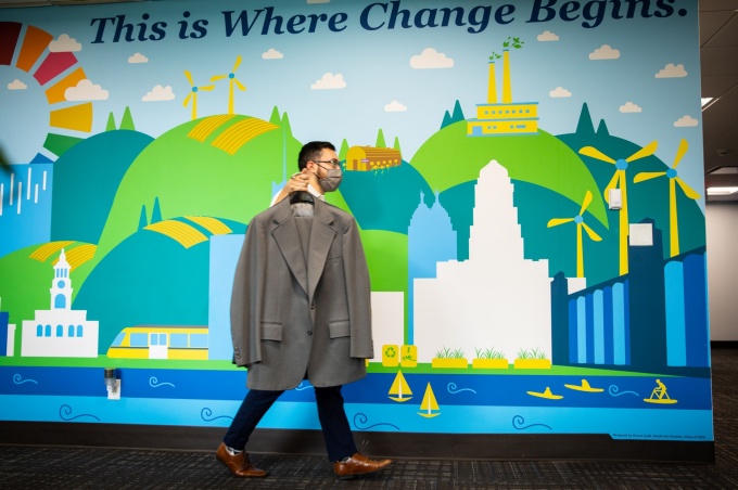 Matthew Taboni carries a suit into the new Hired clothes closet. 