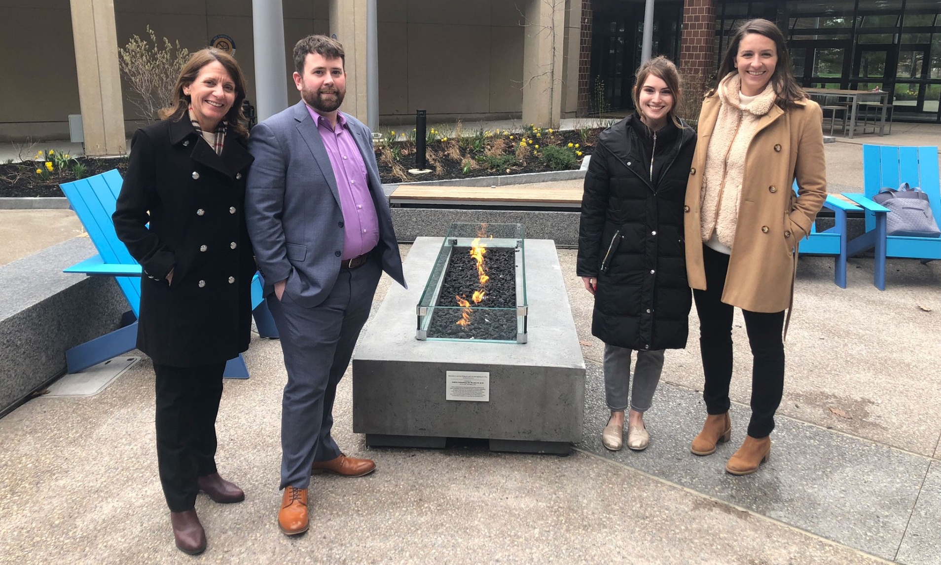 Rosanne Stolzenburg, Adam Wyckoff, Katie Kriner and Anna Stolzenburg stand beside the fire pit dedicated to the late Keith Stolzenburg. 