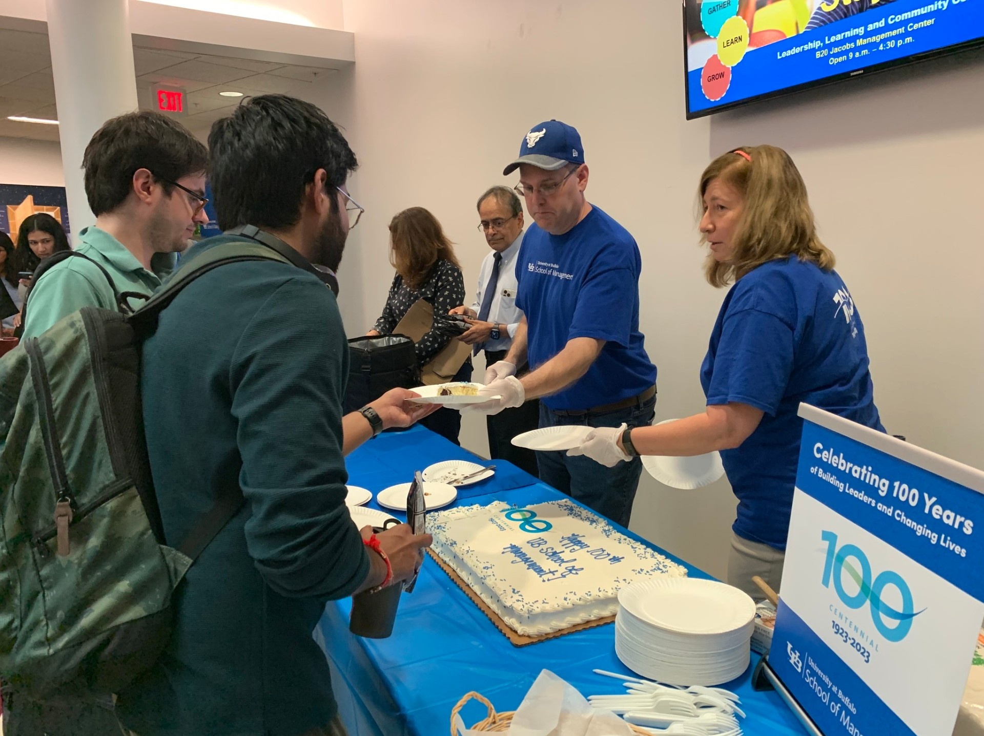 Zoom image: Associate deans Natalie Simpson, Dave Murray and Nallan Suresh handed out cake and ice cream to students.