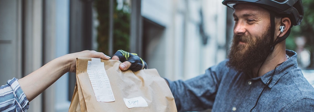 Gig worker delivering food on bicycle. 