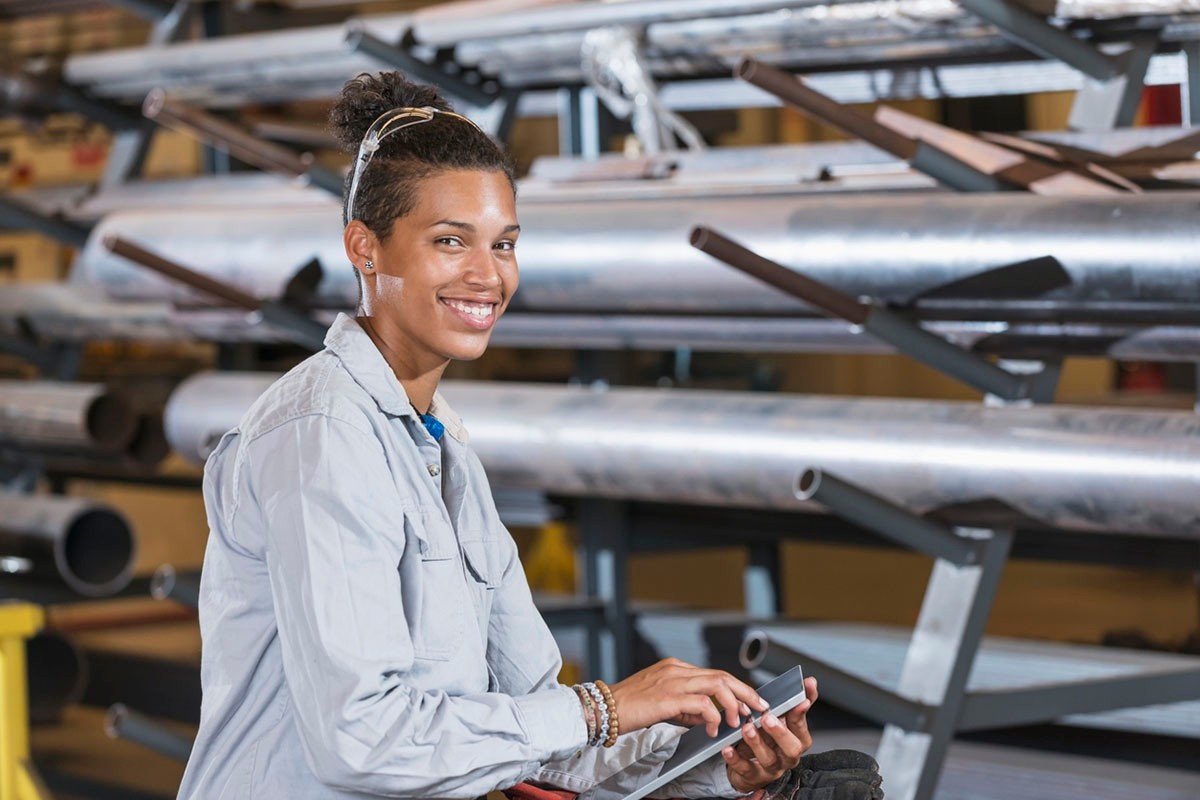 Person in warehouse using a tablet. 