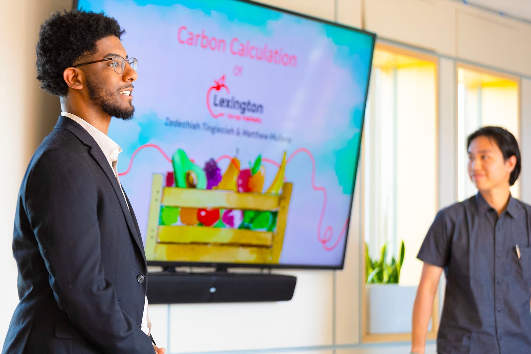 Zoom image: Mullens and Tingiecieh give their Carbon Reduction Challenge presentation in UB’s GRoW Clean Energy Center. Photo: Douglas Levere 