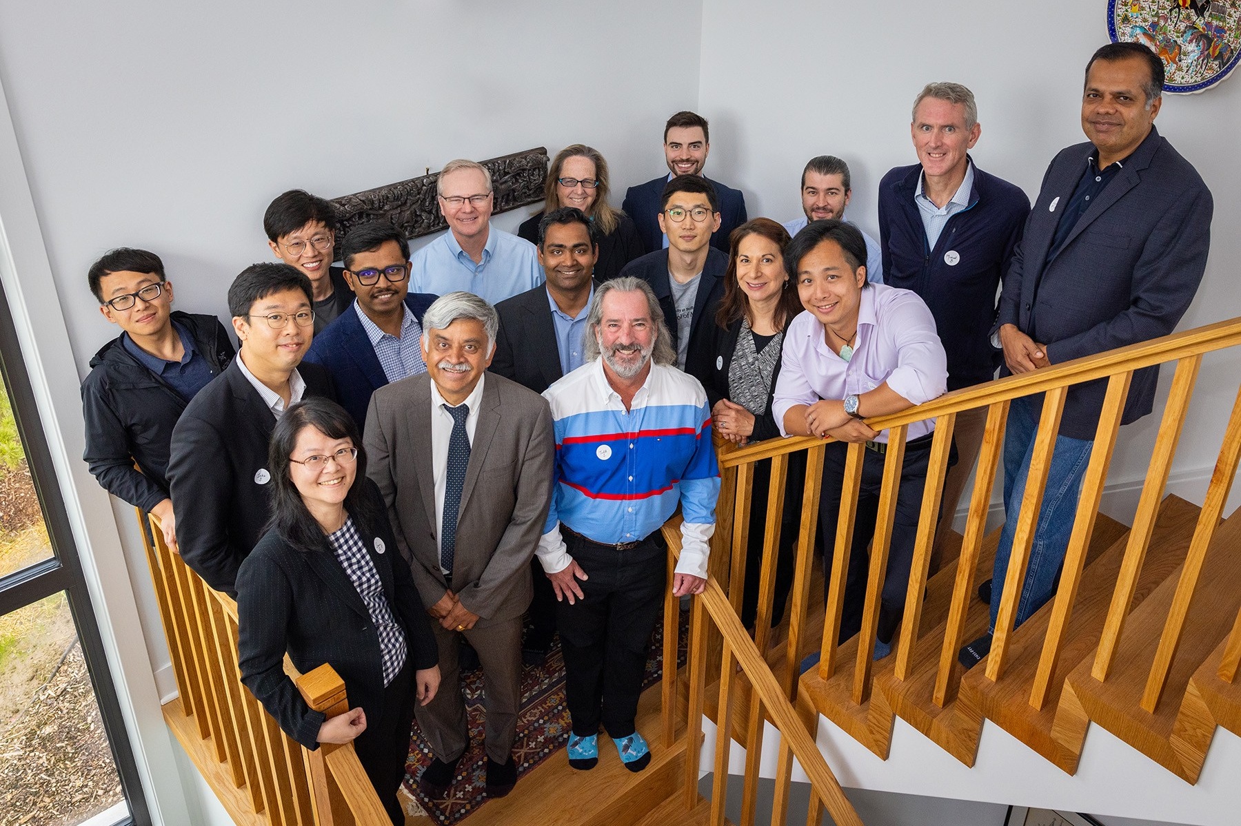 Zoom image: Dean Ananth Iyer (front row, second from left) hosted a reception for new faculty in his home last fall. Photo: Douglas Levere. 