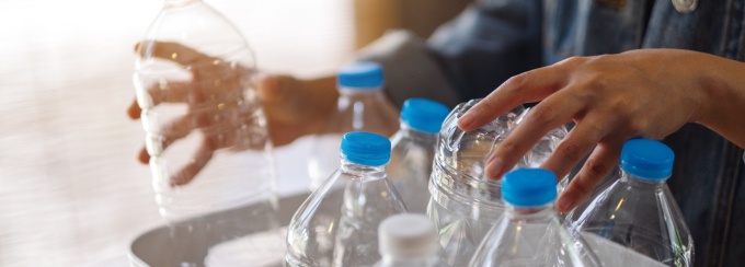 person packing water bottles into a box. 