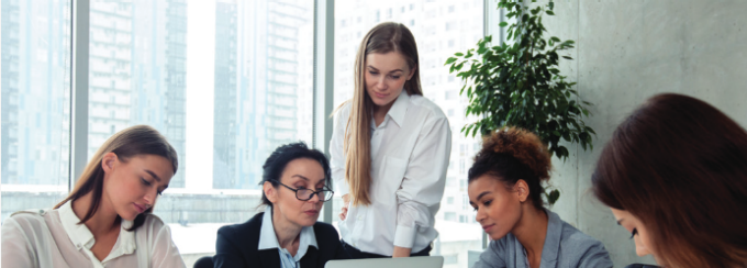 Women in an office working on some documents. 