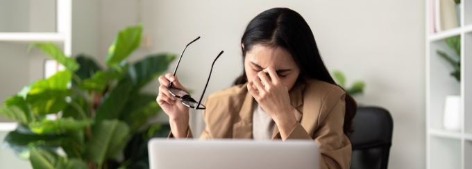 Businessperson overwhelmed in office. 