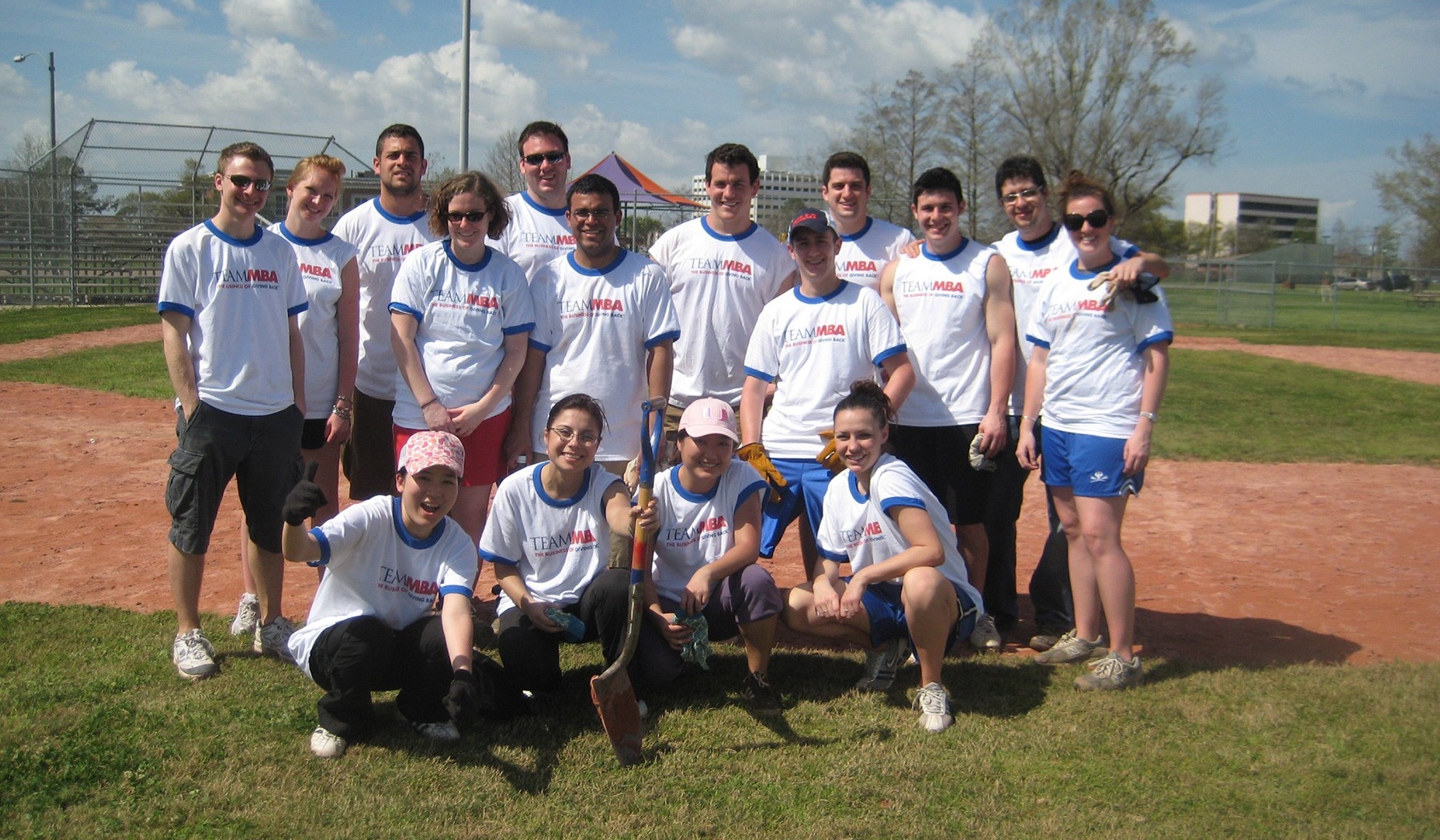 Students posing in a baseball pitch. 