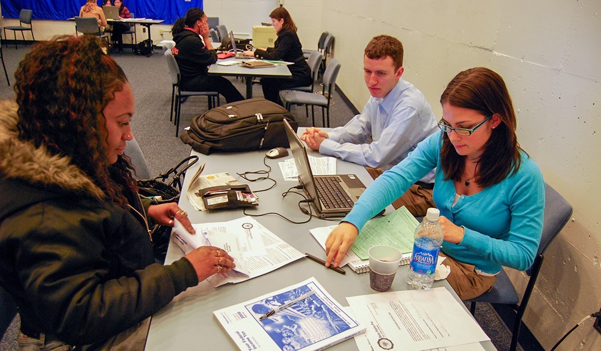 Students working on tax documents. 
