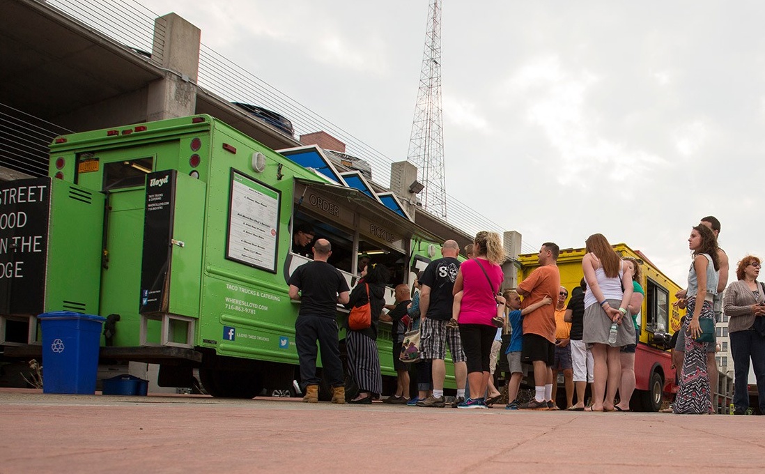 People receiving food from a food truck. 