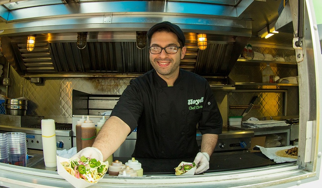 Food truck operator serving food. 