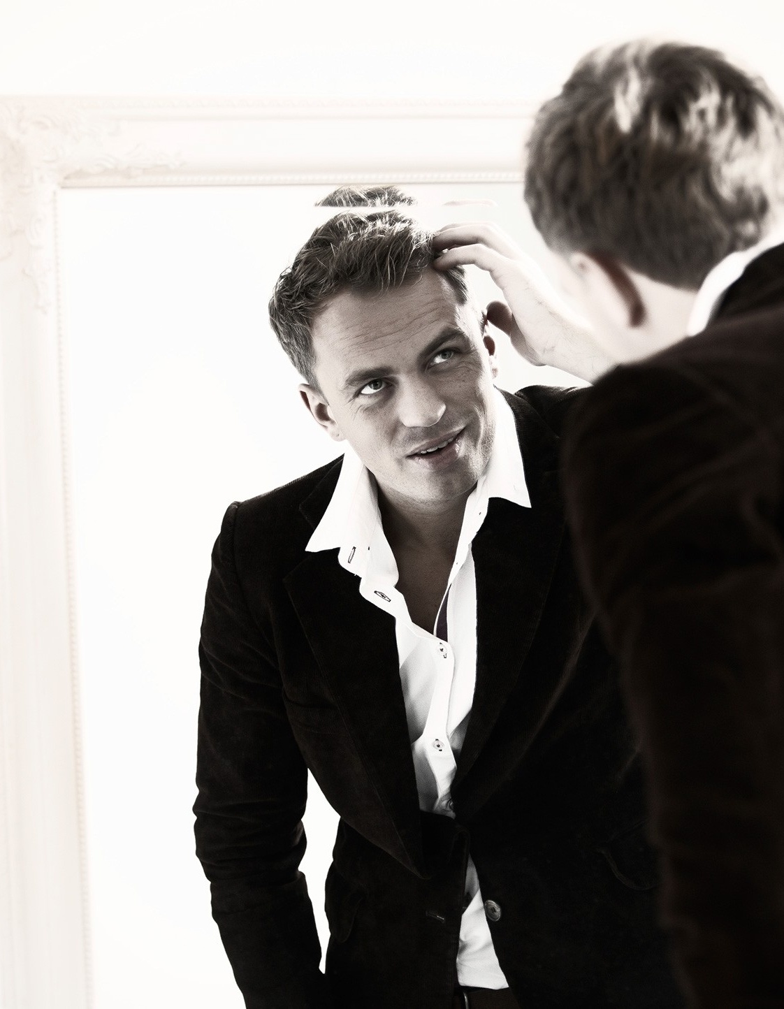 Man looking at himself in the mirror. 