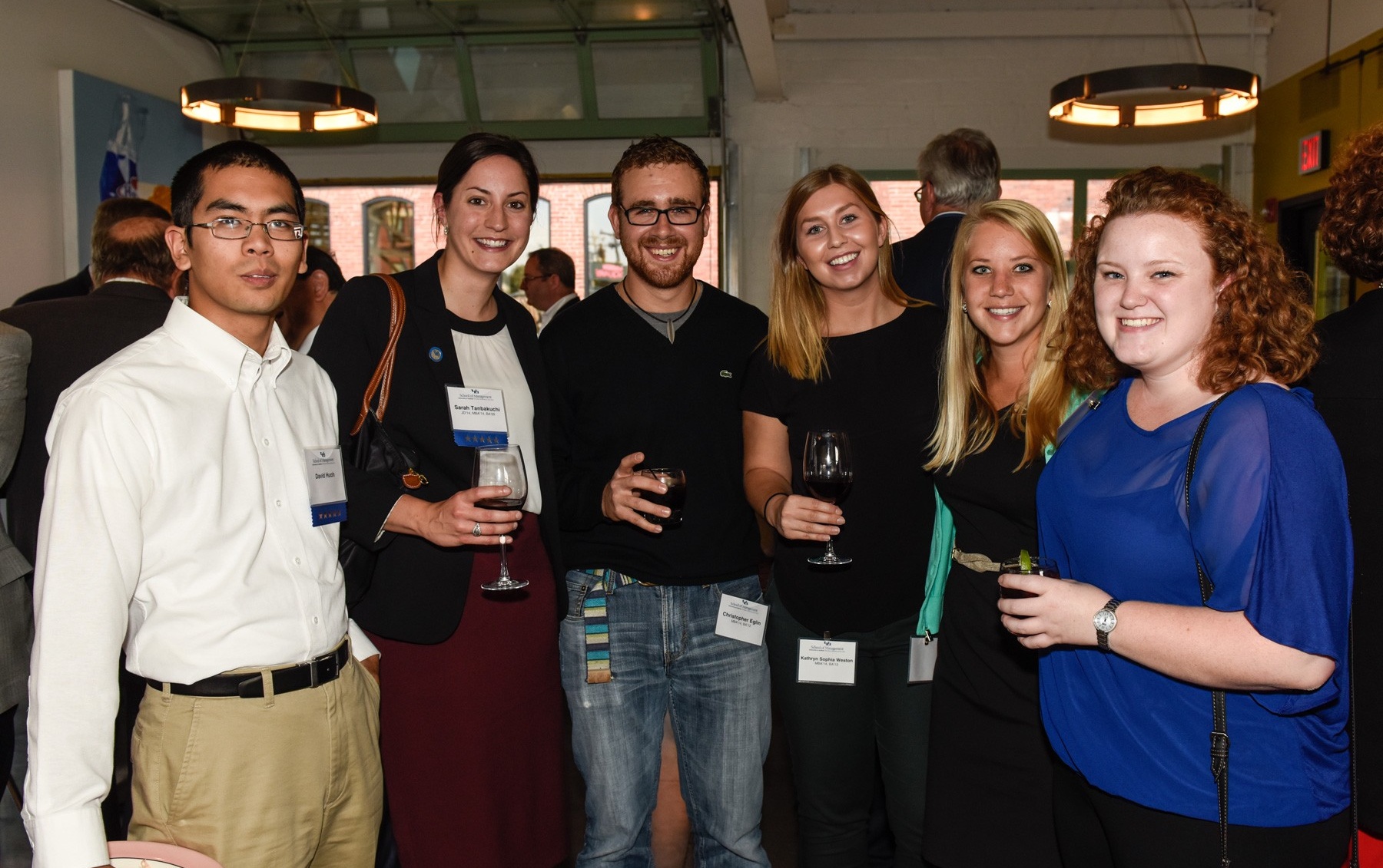 Zoom image: From left: Young Alumni Shareholders and former 2014 Graduate Class Gift Committee members David Huoh; Sarah Tanbakuchi, JD '14, MBA '14, BA '09; Chris Eglin, MBA '14, BA '12; Katie Weston, MBA '14, BA '12; Megan Walck, MBA '14; and Landry Willard, MBA '14. 