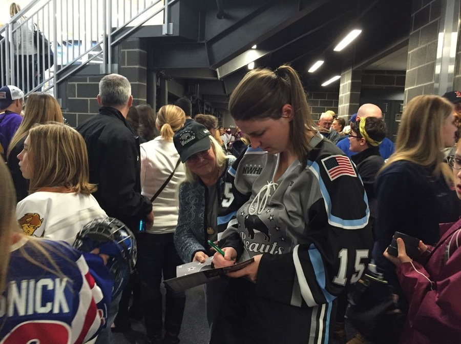Annmarie Cellino signing autographs for kids. 