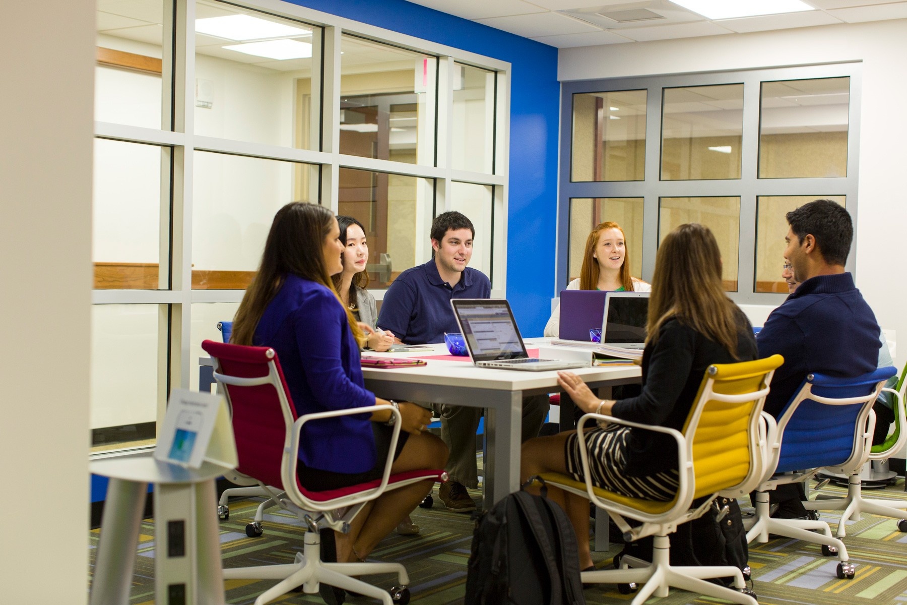 Students sitting discussing in the new undergraduate center. 