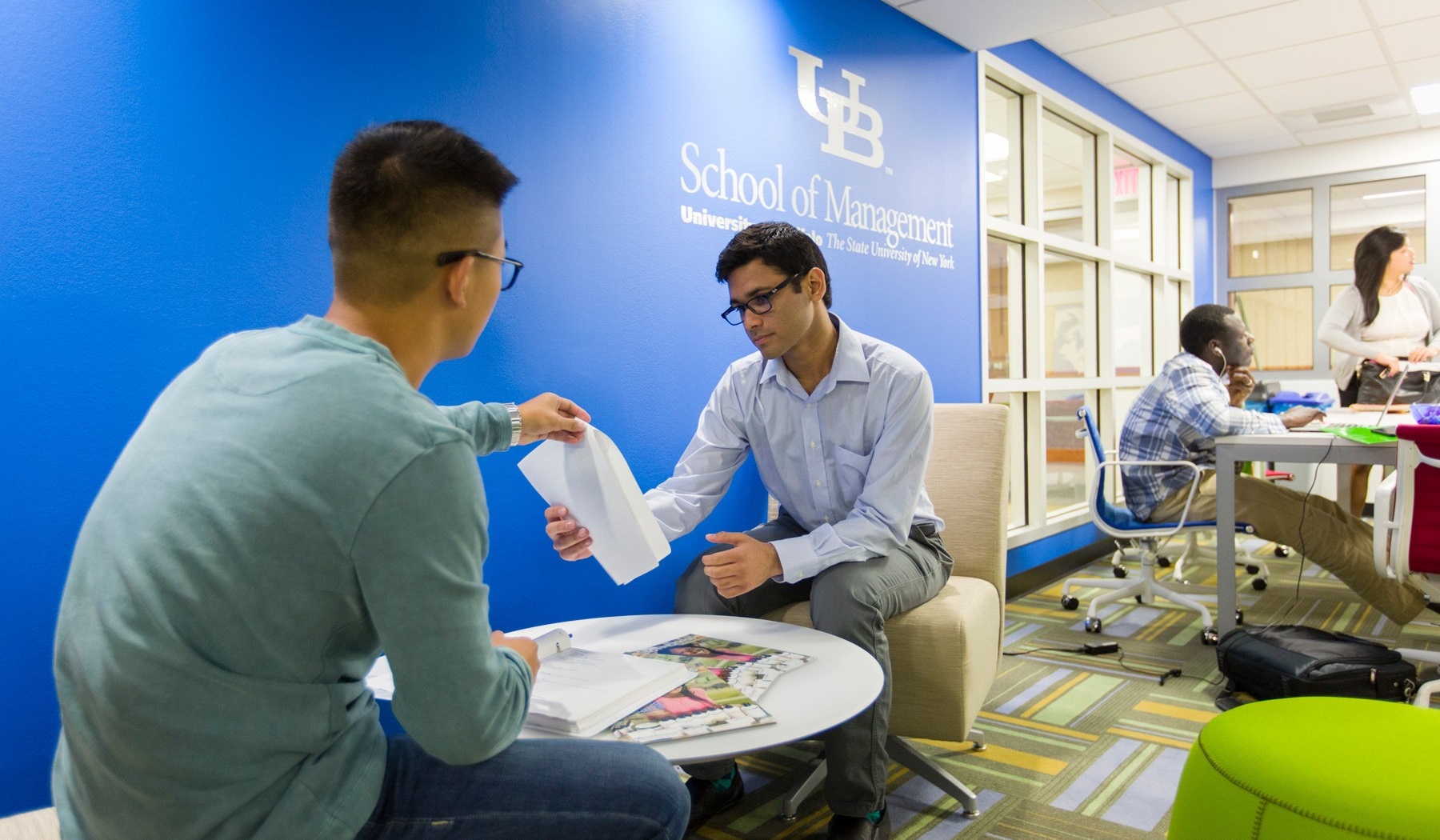 Students sitting discussing in the new undergraduate center. 