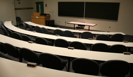 View of a tiered classroom from the back of the room. 