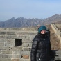 Student standing in front of the Great Wall of China. 