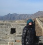 Student standing in front of the Great Wall of China. 