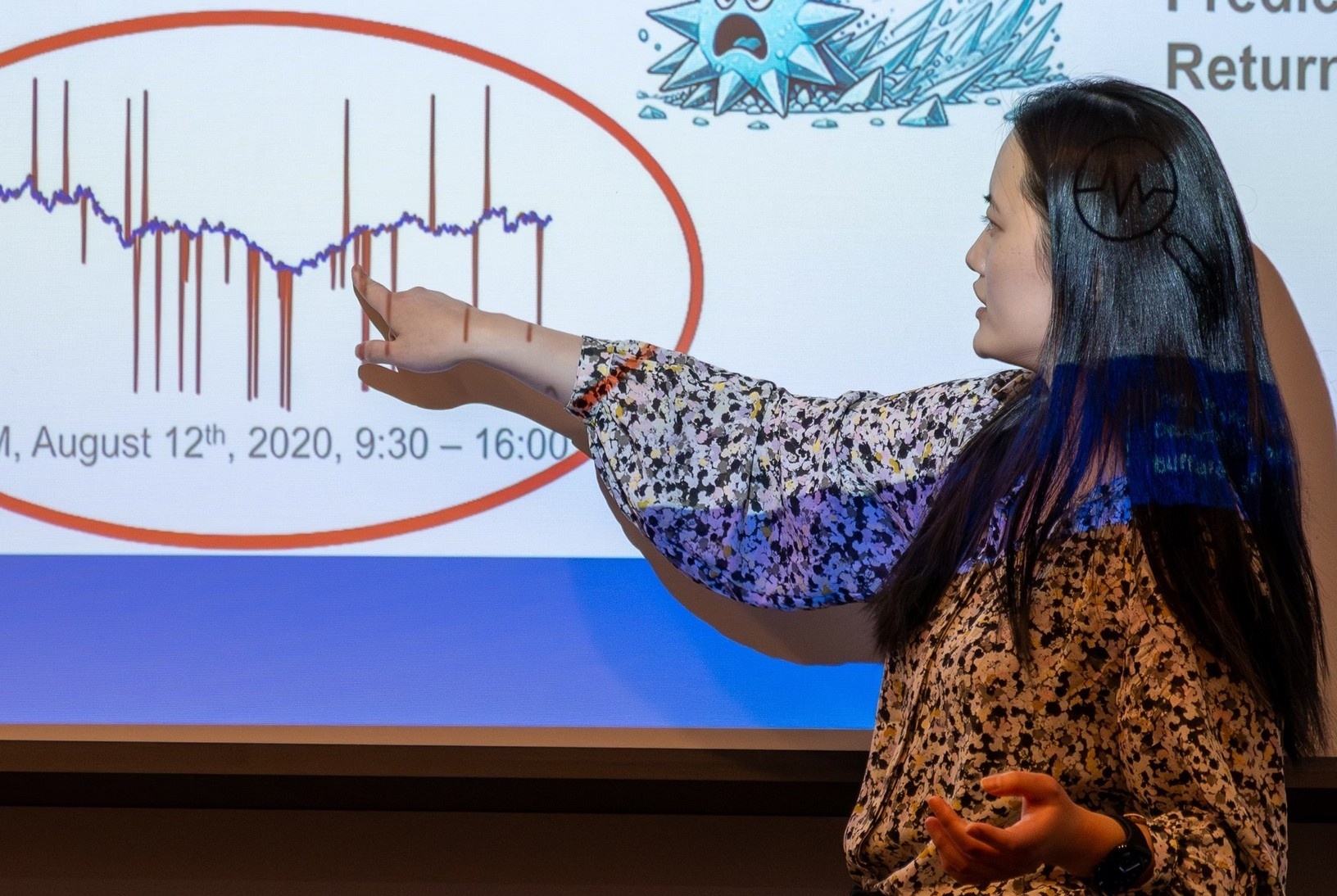 Yu pointing to slide. 