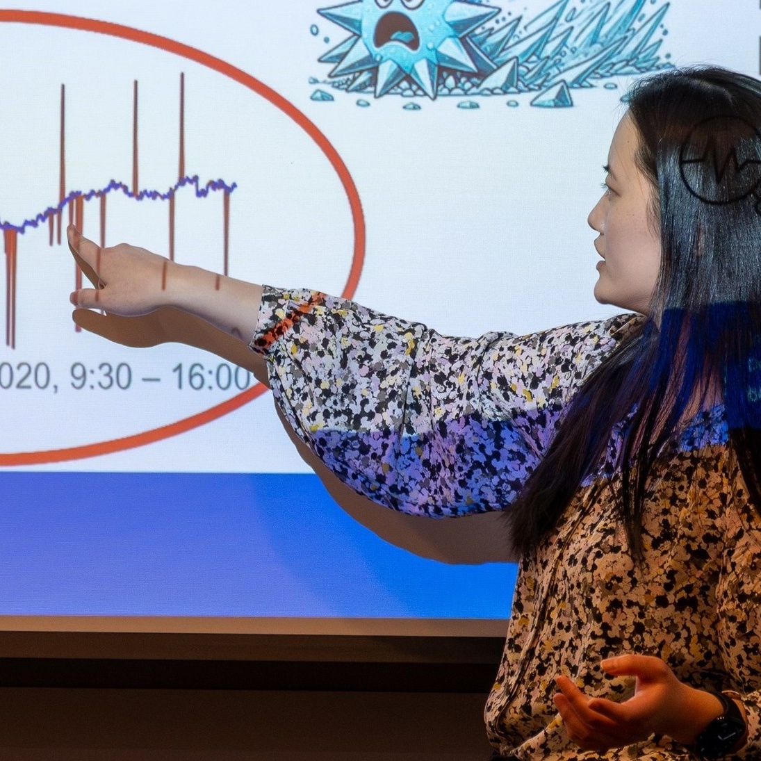 Yu pointing to slide. 