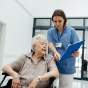 Nurse talking with senior woman, discharging patient from the hospital. 