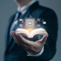Man holding a book with AI icons emerging from it. 