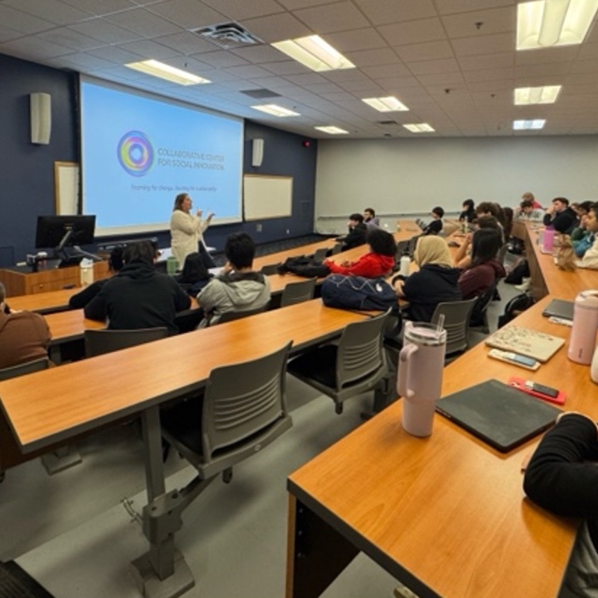 Students in a classroom listening to a professor. 