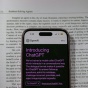 Chat GPT on a phone on top of a book. 