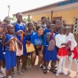 MBA/MPH student Danielle Vazquez surrounded by schoolchildren in Ghana. 