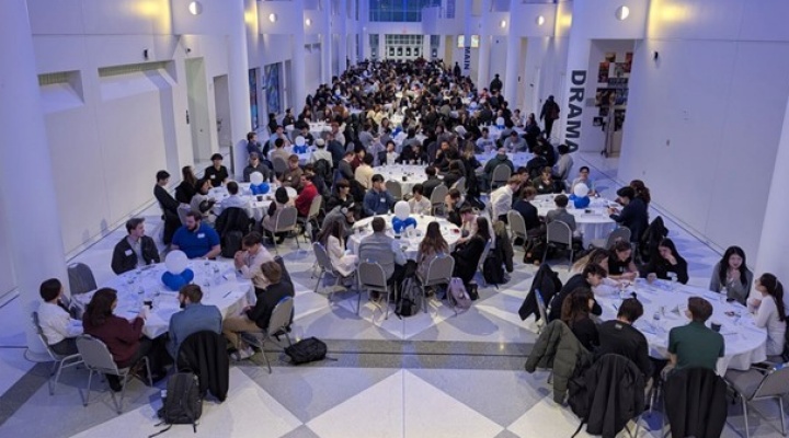 Room full of people networking. 